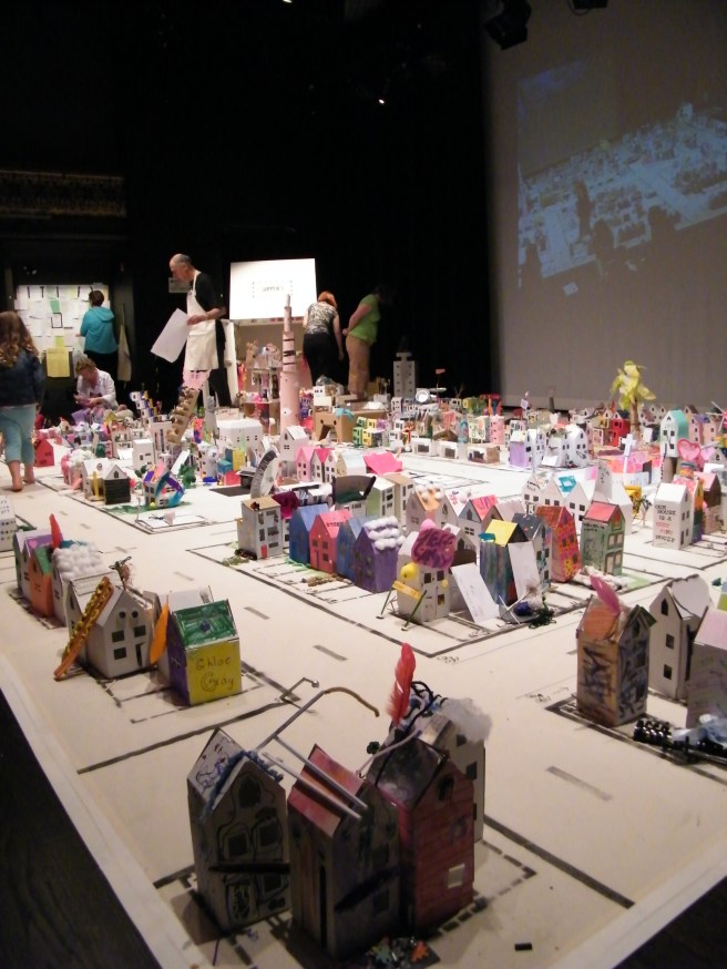 The village, with one of the installation workers in the background. To the right, you can see the screen where the goings-on were projected.