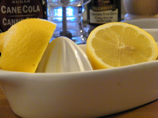 A split lemon resting in the juicer.