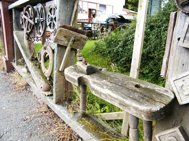 An interesting handmade fence in front of a house.