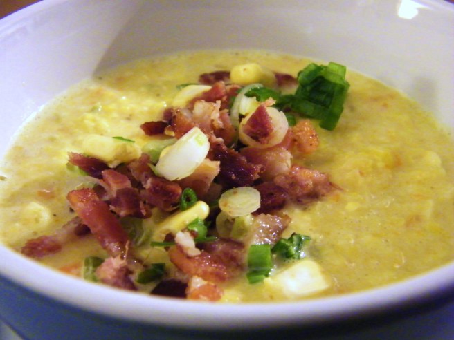 The finished soup, with a garnish of green onion, bacon, corn kernels and a little cayenne.