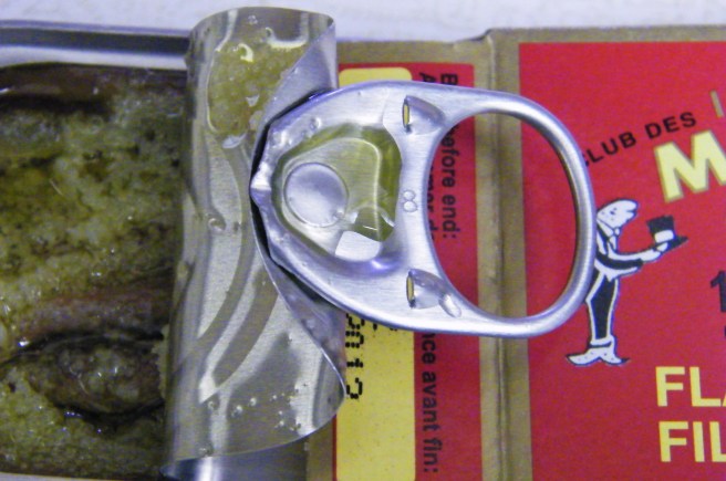 Opening the can of anchovies.