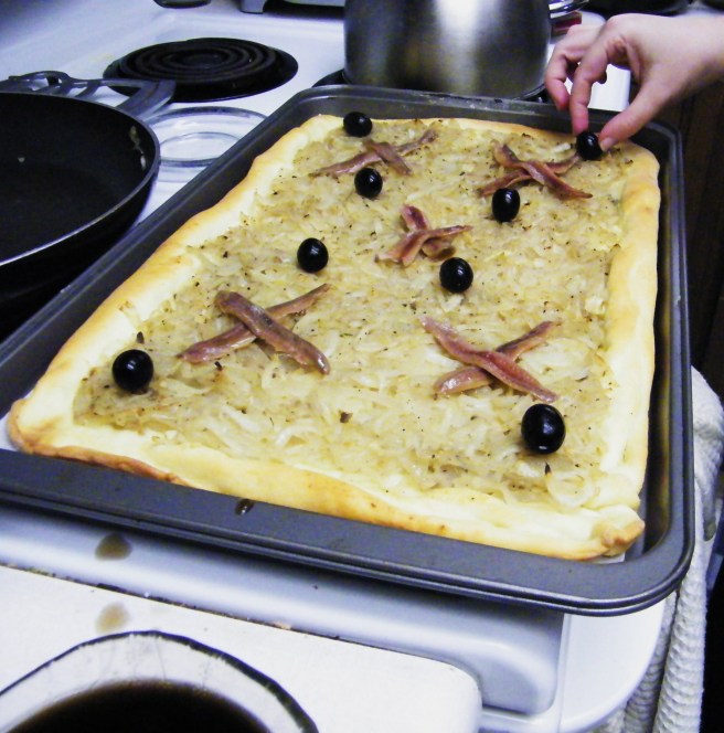 Adding the olives and anchovies.