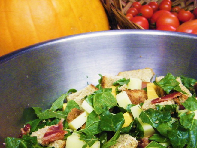 Mixing the pumpkin stuffing, with the pumpkin and some tomatoes in the background.