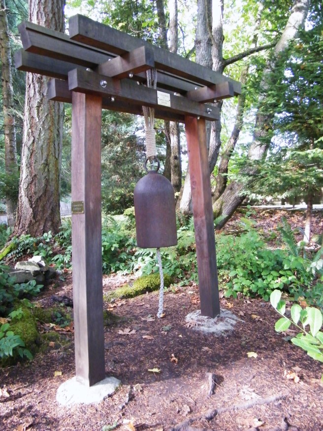 A bell along the forest path to Mayne Island's Japanese Garden.