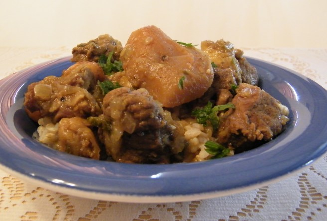 The finished stew, in a blue soup plate, on a lace tablecloth.