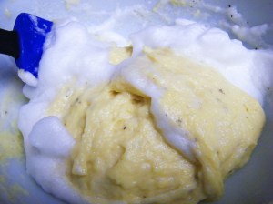 Adding the whipped egg whites to the matafan batter.