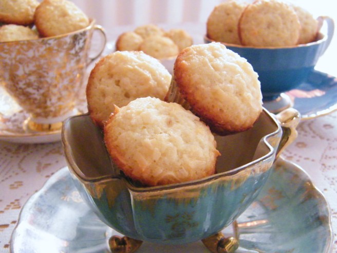Coconut friands piled in teacups